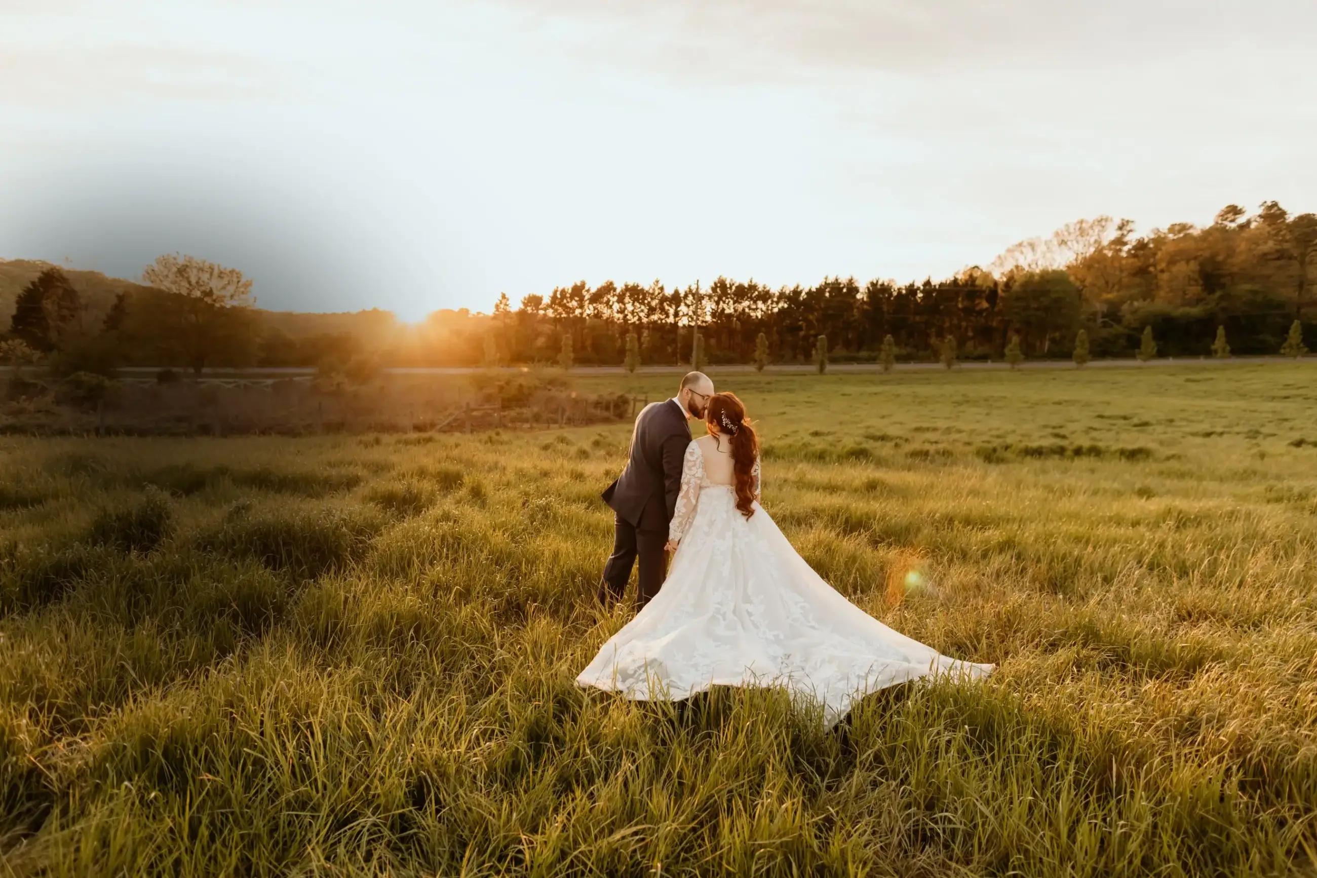 Сouple wearing a white gown and a black suit in the sunset